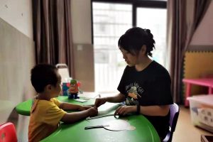 Hong-mei provides individual training for a child with ASD